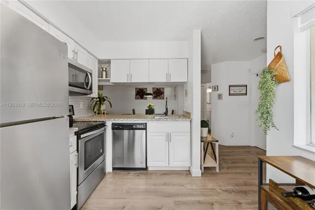 a kitchen with a sink cabinets and stainless steel appliances