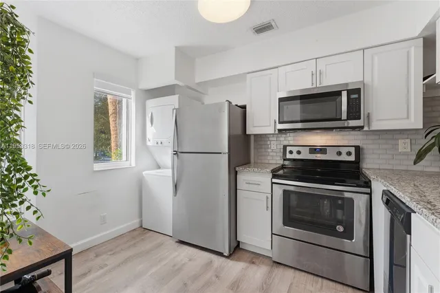 a kitchen with a stove a microwave and a refrigerator