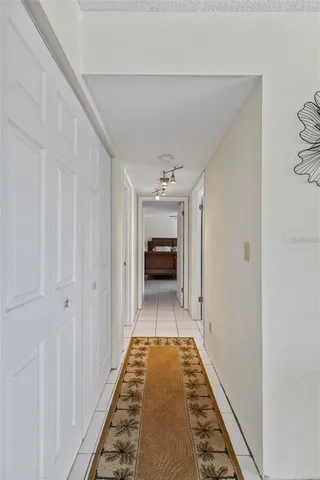 a hallway view with staircase