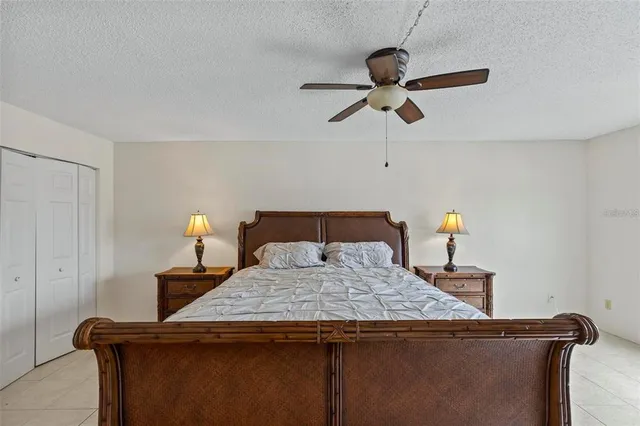 a bedroom with a bed and ceiling fan