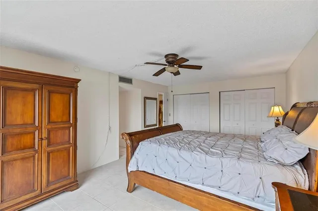 a bedroom with a bed and ceiling fan