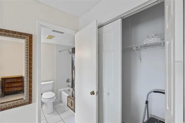 a bathroom with a granite countertop toilet a sink and shower