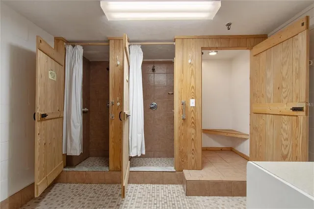 a bathroom with a glass shower door