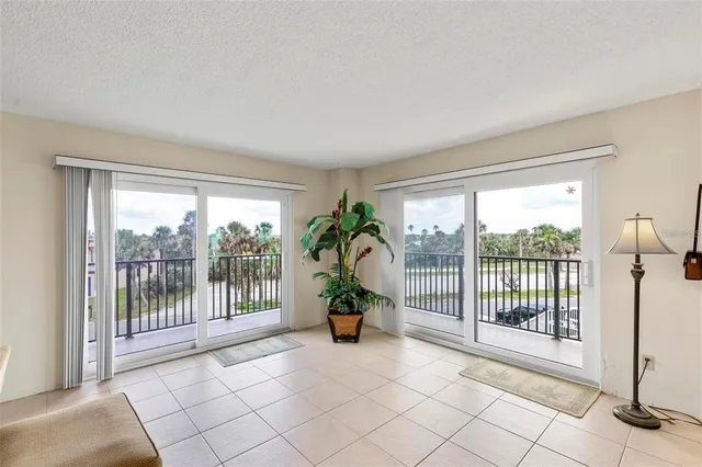 a living room with a floor to ceiling window and a table