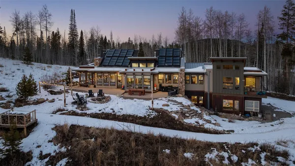 a view of a house with a yard and sitting area