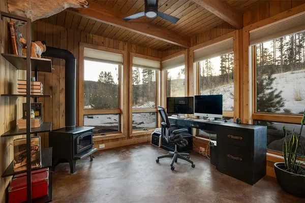 a view of a livingroom with workspace and a window