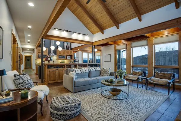 a living room with furniture and a chandelier
