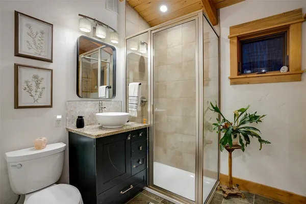 a bathroom with a toilet sink and a shower