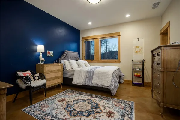 a bedroom with bed and a couch