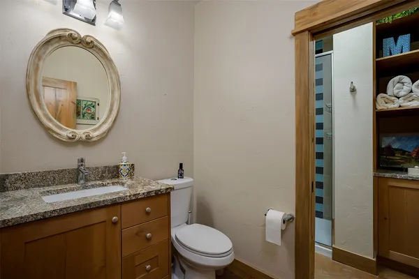 a bathroom with a toilet a sink and a mirror