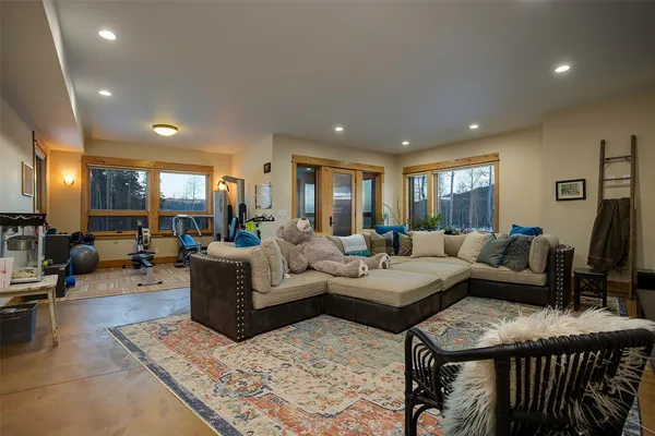 a living room with furniture and a view of kitchen