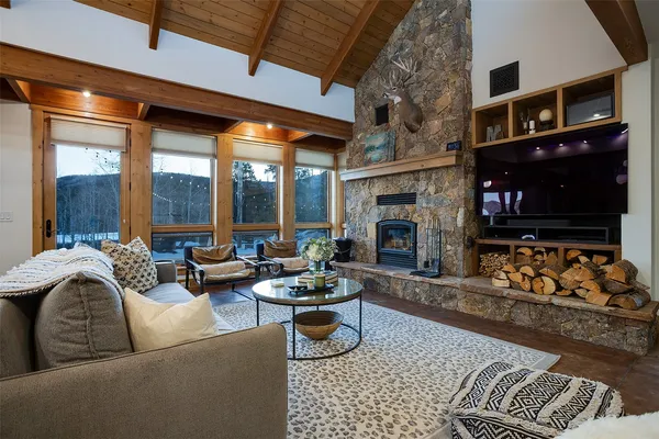 a living room with furniture fireplace and flat screen tv