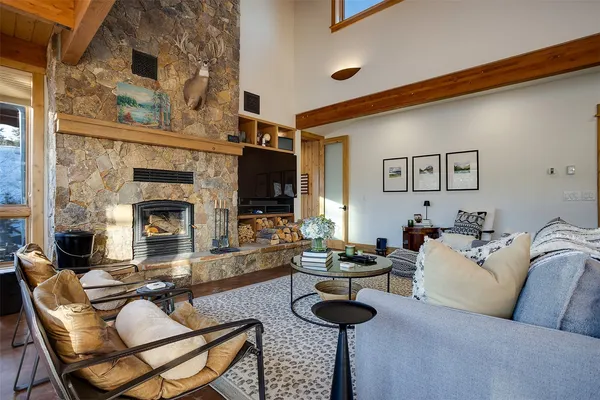 a living room with furniture and a fireplace