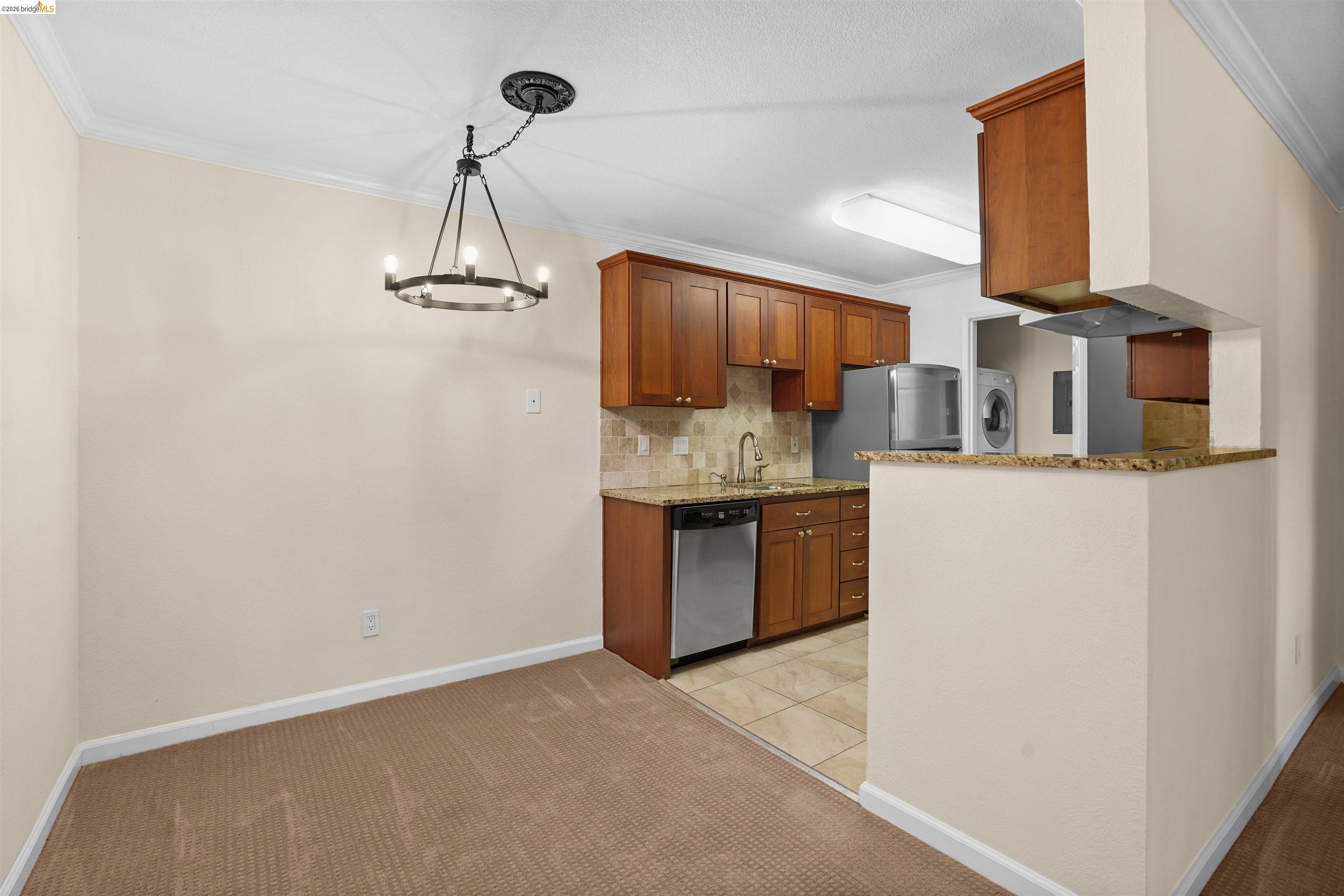 1505 Kirker Pass Road, Unit 214 Concord, CA 94521 - Photo 13 of 55 Dining area featuring a circular chandelier with an adjacent kitchen