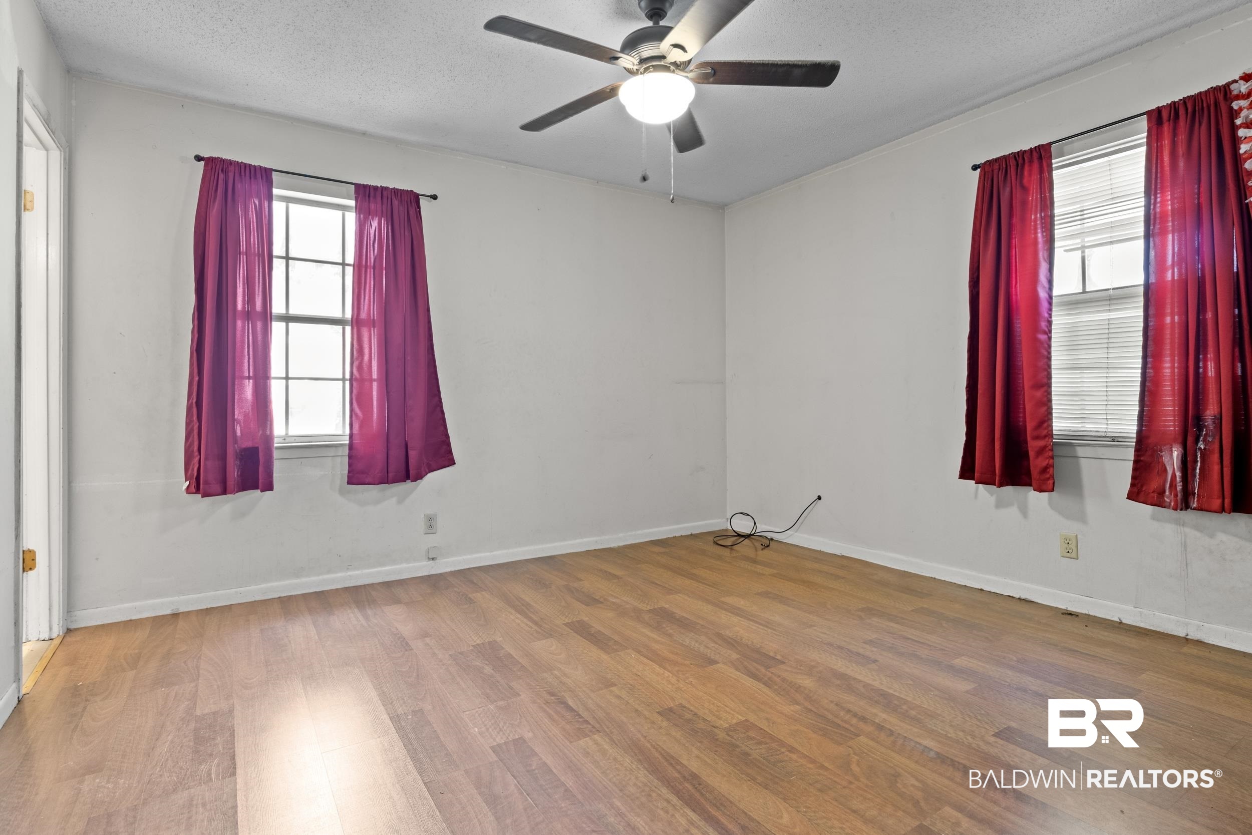 8701 A Rosemary Road Eight Mile, AL 36613 - Photo 14 of 27 Unfurnished room with a textured ceiling, hardwood / wood-style floors, and ceiling fan