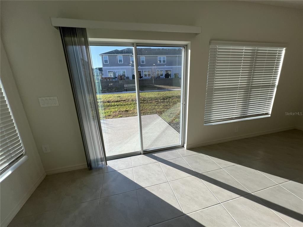 758 Stoney Point Circle Davenport, FL 33896 - Photo 13 of 42 a view of an empty room with a fireplace
