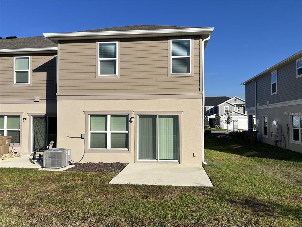 758 Stoney Point Circle Davenport, FL 33896 - Photo 15 of 42 a front view of a house with a yard