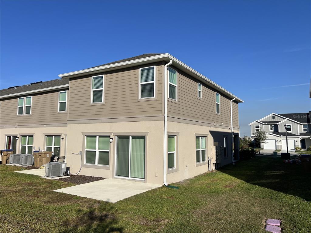 758 Stoney Point Circle Davenport, FL 33896 - Photo 16 of 42 a front view of a house with a yard