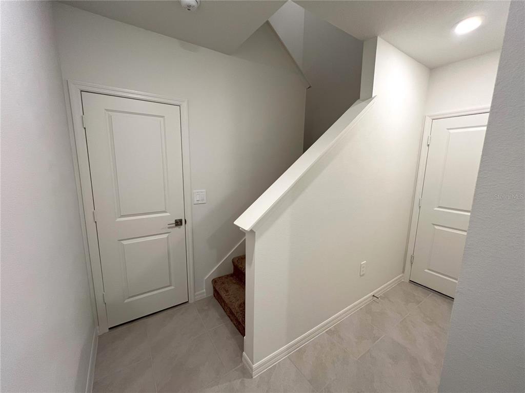 758 Stoney Point Circle Davenport, FL 33896 - Photo 17 of 42 a view of hallway with stairs