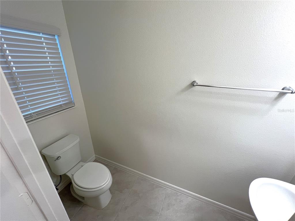 758 Stoney Point Circle Davenport, FL 33896 - Photo 18 of 42 a white toilet sitting next to a shower