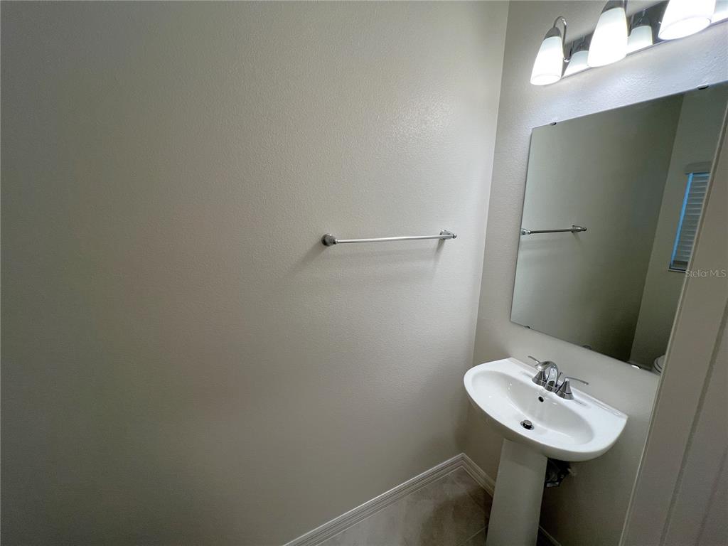 758 Stoney Point Circle Davenport, FL 33896 - Photo 19 of 42 a bathroom with a sink and a mirror