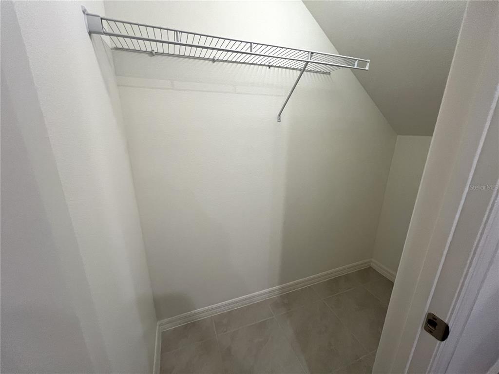 758 Stoney Point Circle Davenport, FL 33896 - Photo 22 of 42 a view of a room with racks on the wall