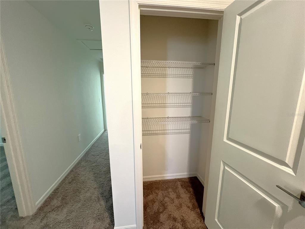 758 Stoney Point Circle Davenport, FL 33896 - Photo 25 of 42 a view of walk in closet with empty racks