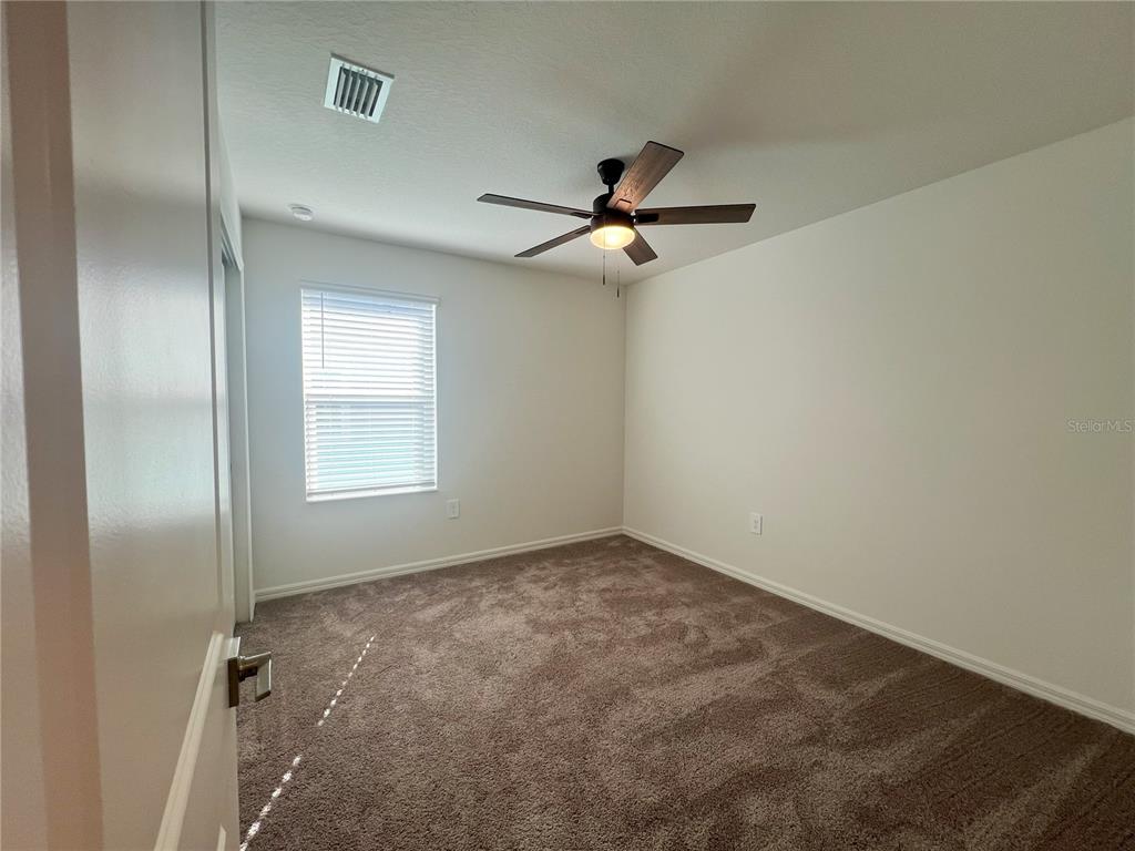 758 Stoney Point Circle Davenport, FL 33896 - Photo 27 of 42 a view of room with a ceiling fan and window