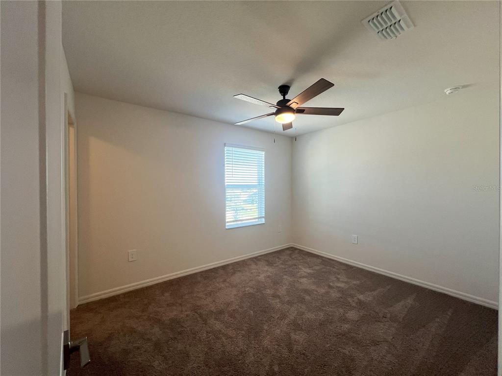 758 Stoney Point Circle Davenport, FL 33896 - Photo 29 of 42 an empty room with a window