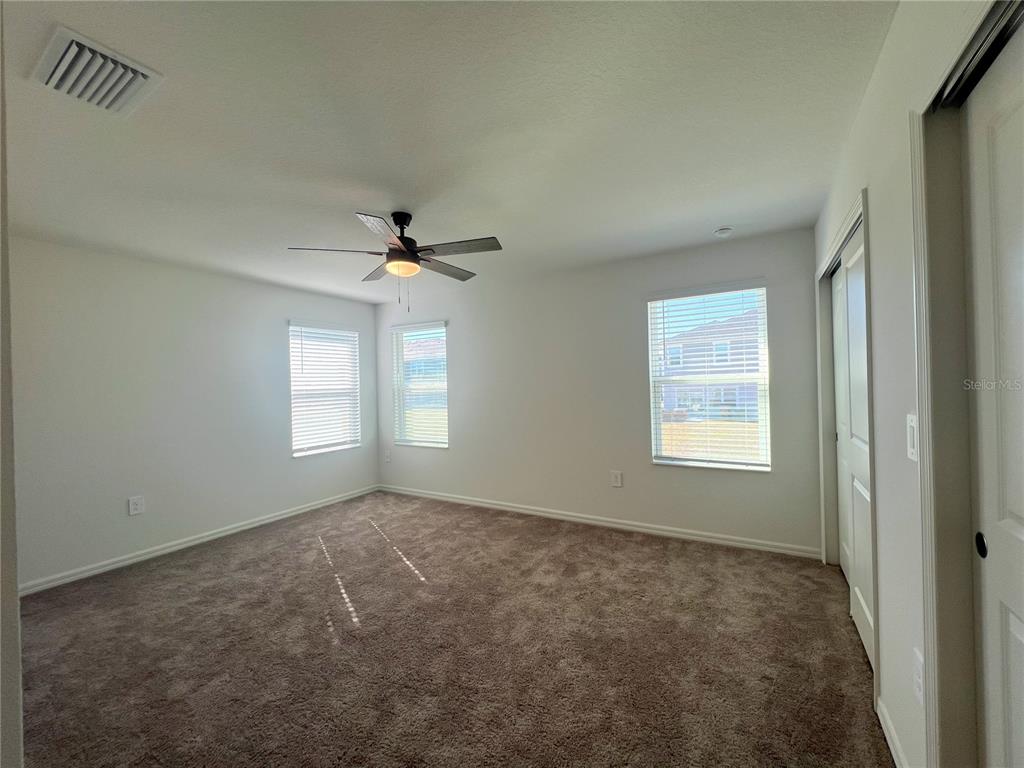 758 Stoney Point Circle Davenport, FL 33896 - Photo 35 of 42 a view of a livingroom with a ceiling fan and window