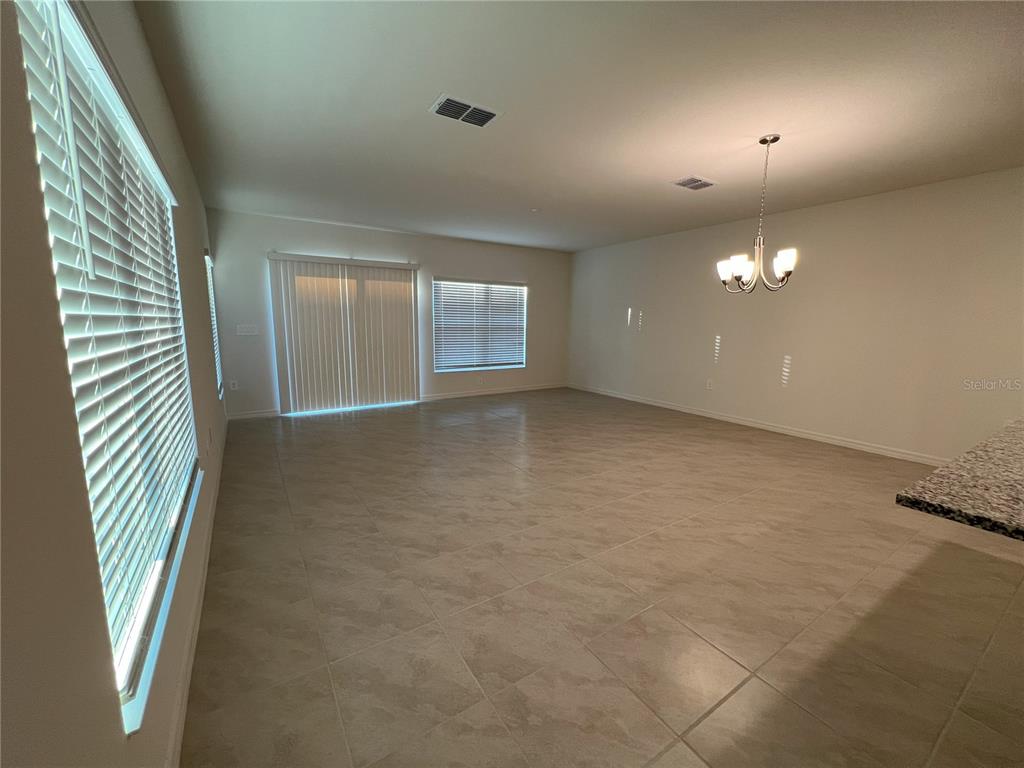 758 Stoney Point Circle Davenport, FL 33896 - Photo 10 of 42 an empty room with windows and brick walls