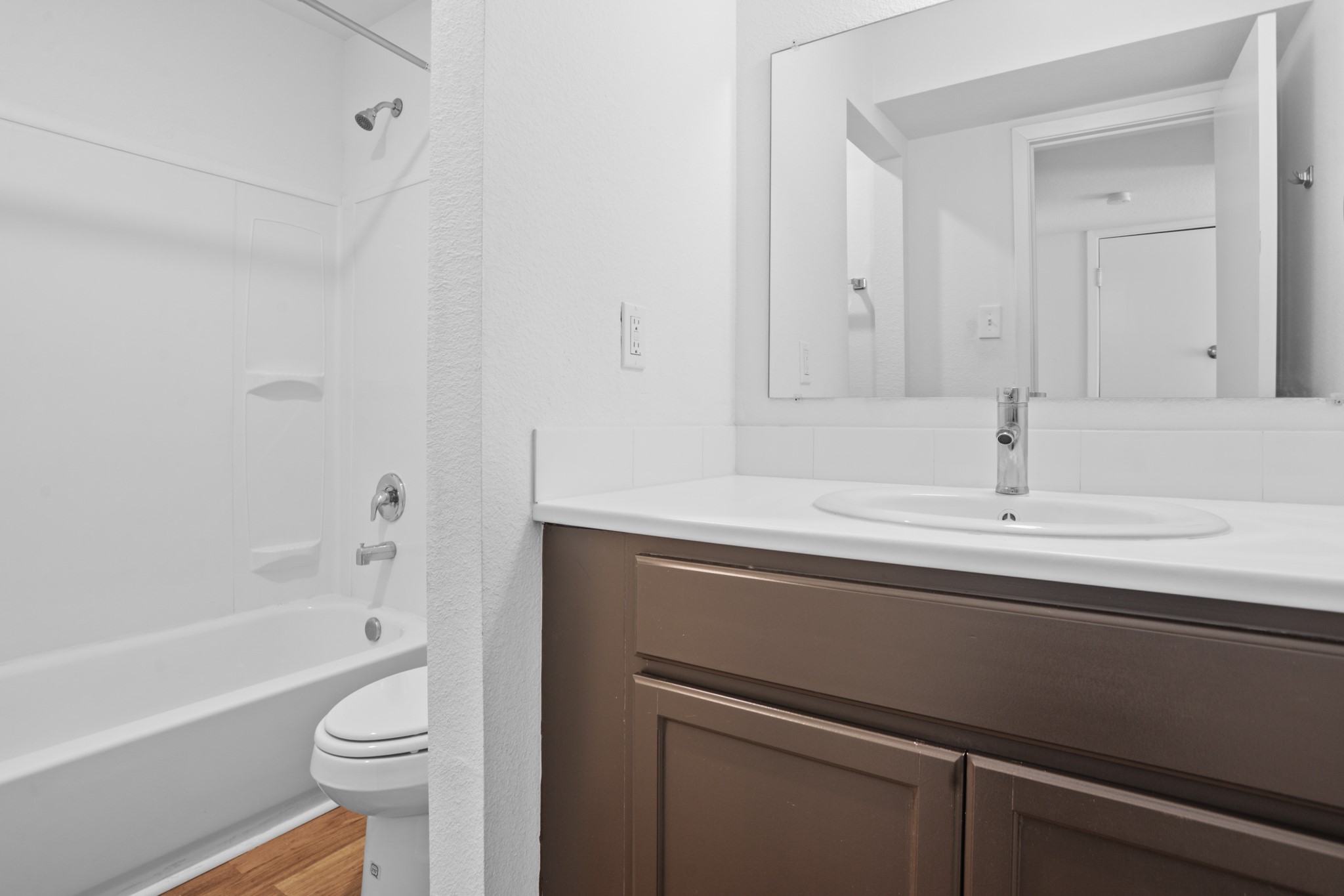 1408 Hughes Street, Unit 4 Houston, TX 77023 - Photo 25 of 27 The bathroom has been updated with quartz countertop, cabinetry, tub surround, sink and contemporary faucet.