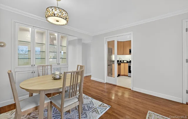 a view of a dining room with furniture wooden floor and a window