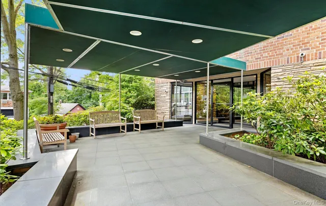 a couple of chairs and a table in the patio