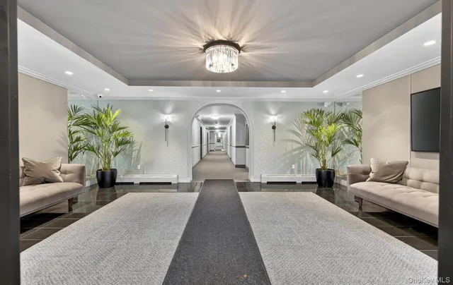 a living room with furniture and a chandelier