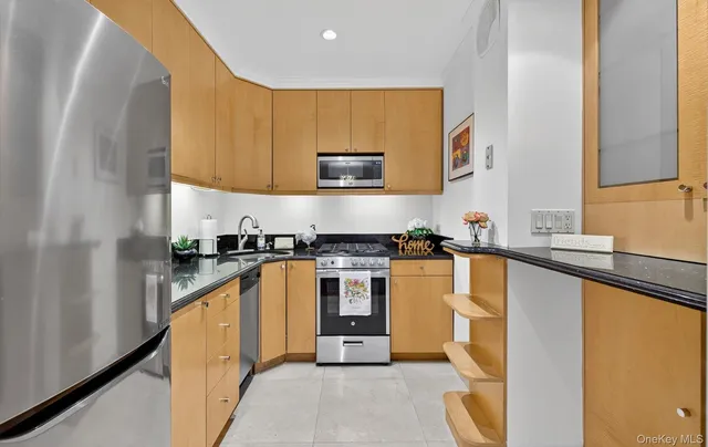 a kitchen with stainless steel appliances granite countertop a sink and a stove top oven
