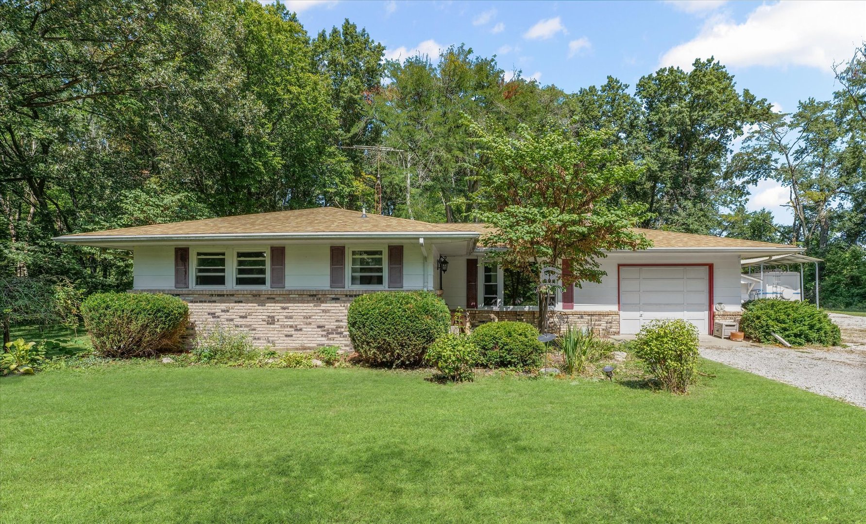 a front view of house with yard and green space