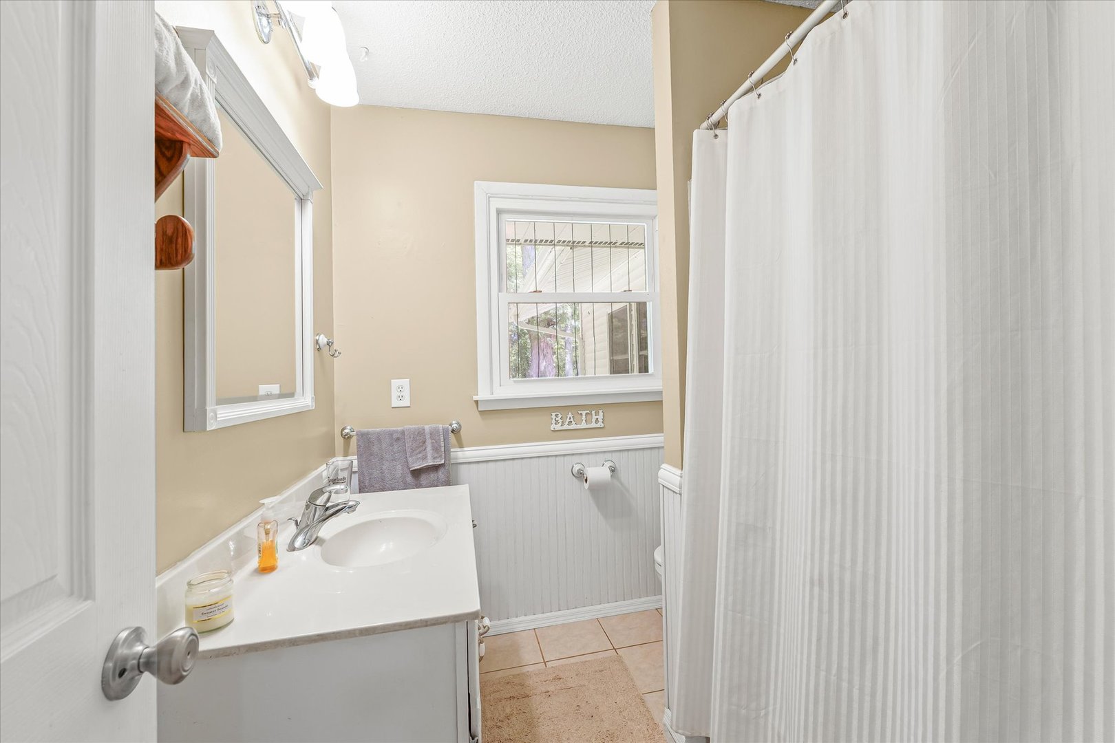 9835 East 1610 North Road Oakwood, IL 61858 - Photo 23 of 35 a bathroom with a sink a mirror and a window