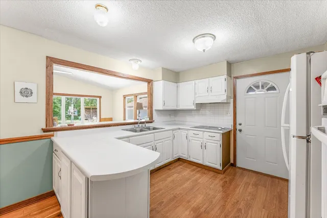 a kitchen with a stove a sink and a refrigerator