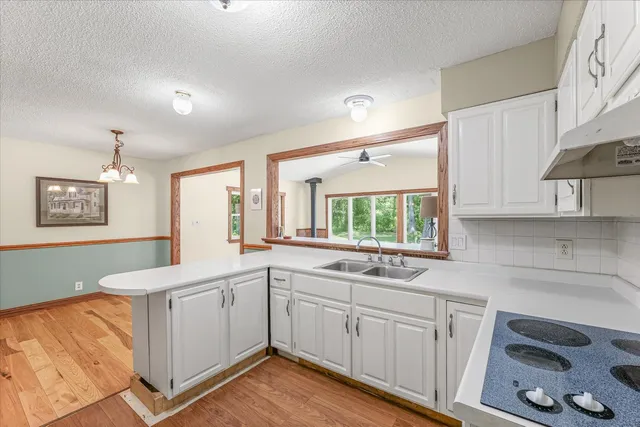a kitchen that has a sink and a stove in it