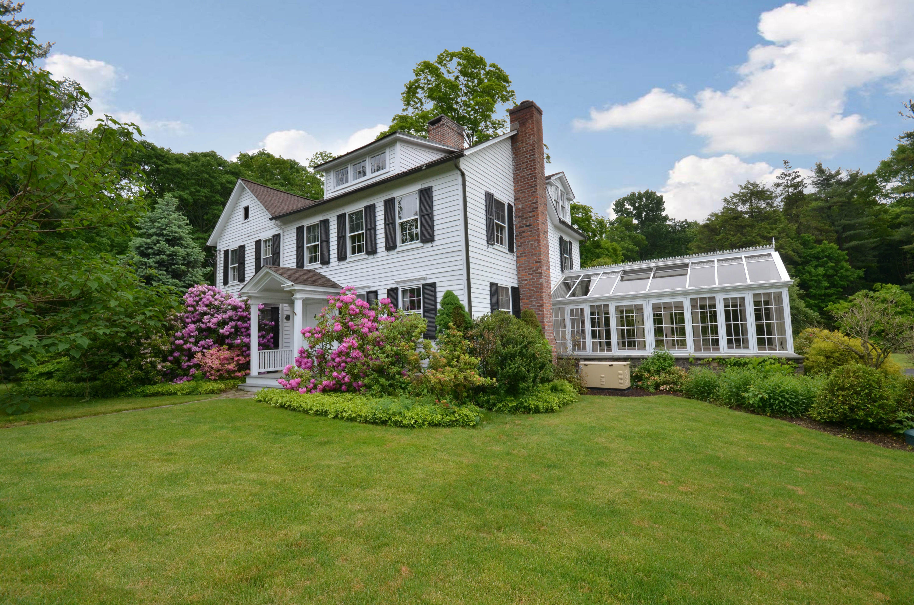 1462 Oenoke Ridge New Canaan, CT 06840 - Photo 1 of 25 a front view of a house with a garden