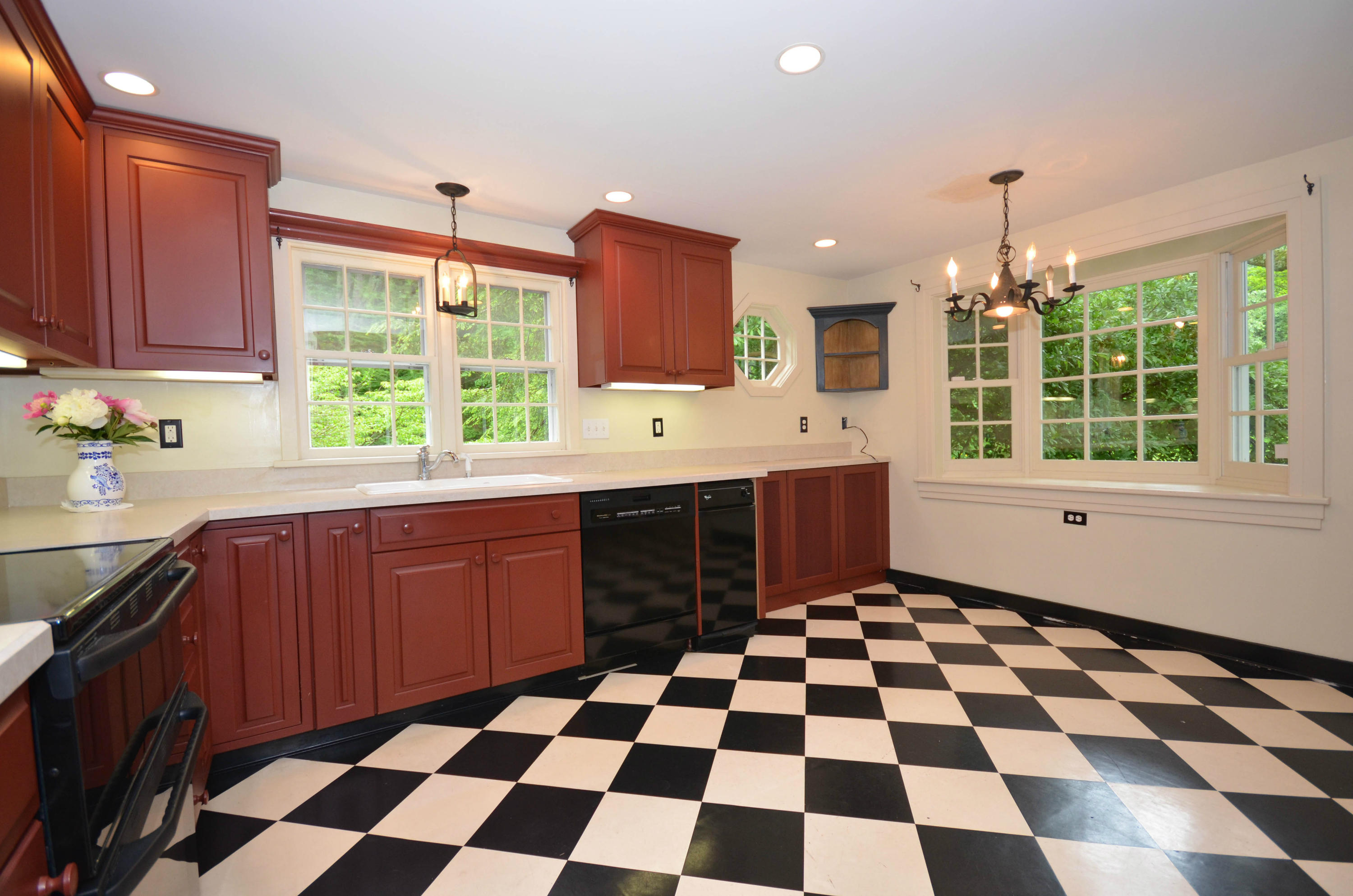 1462 Oenoke Ridge New Canaan, CT 06840 - Photo 11 of 25 a kitchen with a sink a window and stainless steel appliances