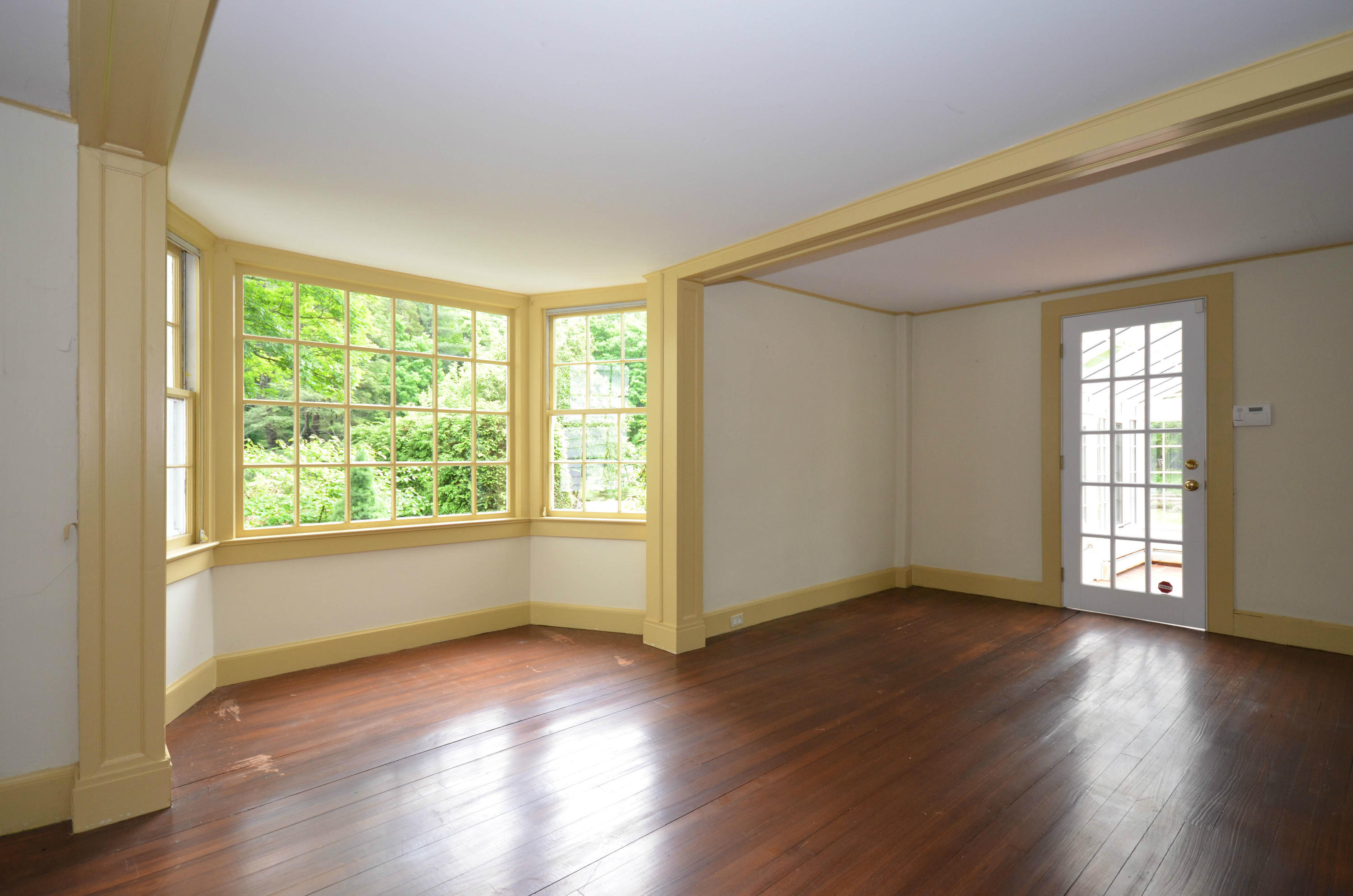 1462 Oenoke Ridge New Canaan, CT 06840 - Photo 13 of 25 a view of an empty room with wooden floor and a window