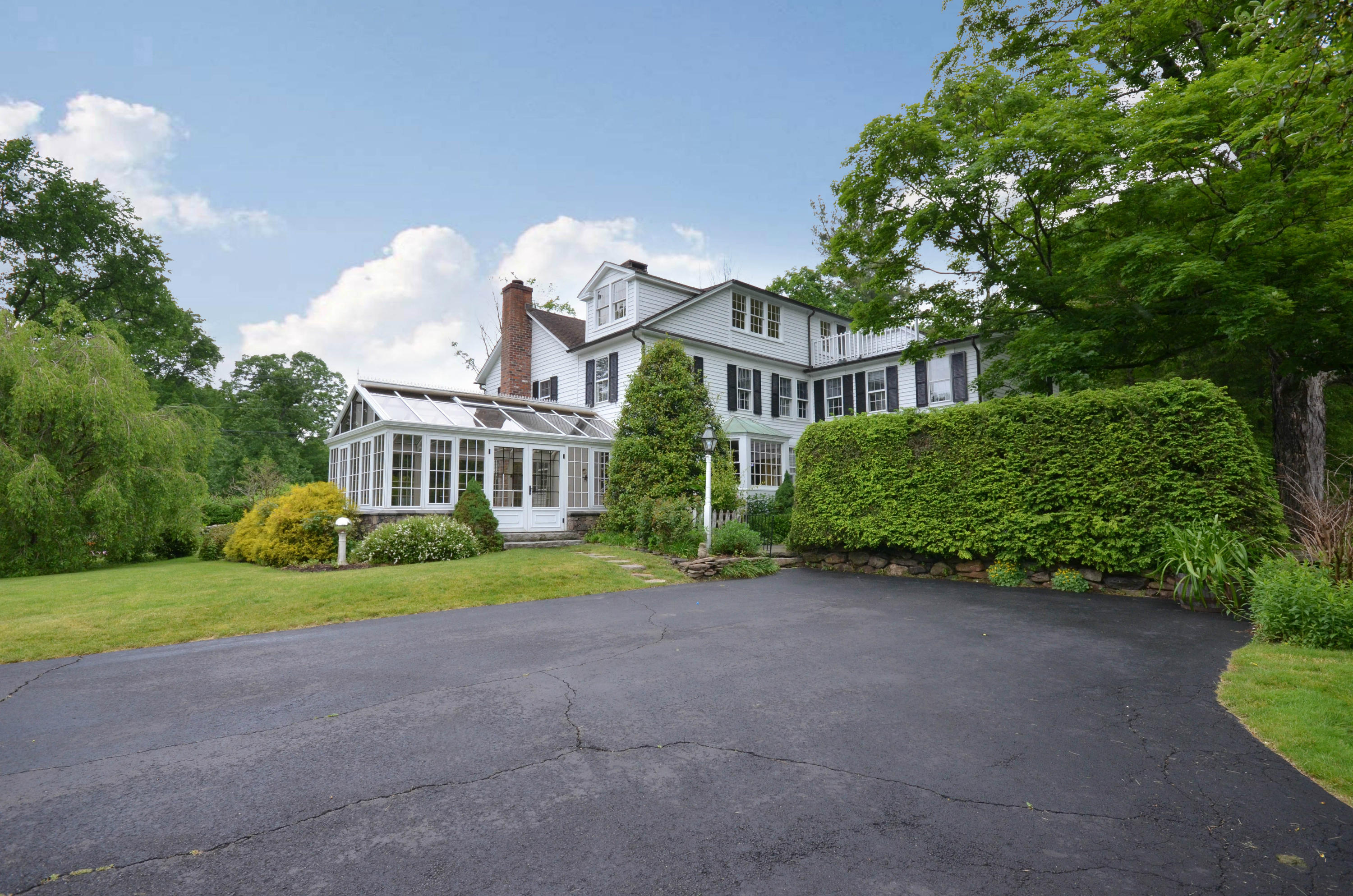 1462 Oenoke Ridge New Canaan, CT 06840 - Photo 2 of 25 a front view of a house with garden
