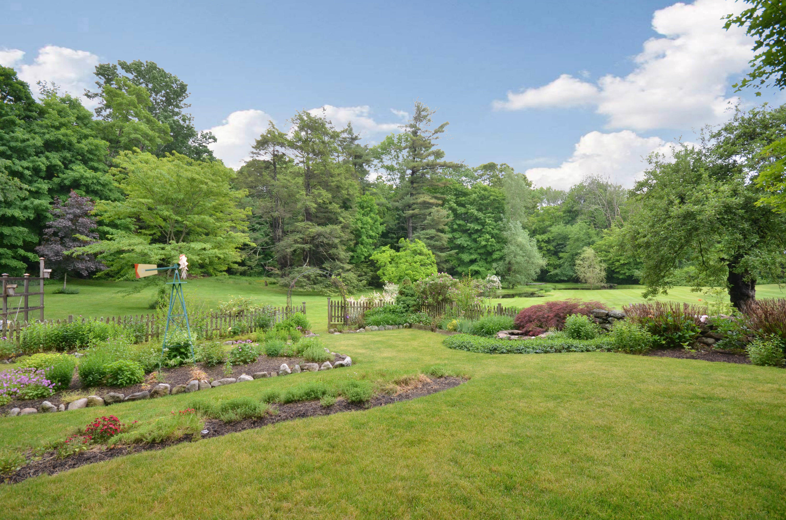 1462 Oenoke Ridge New Canaan, CT 06840 - Photo 21 of 25 a view of a lake with a yard