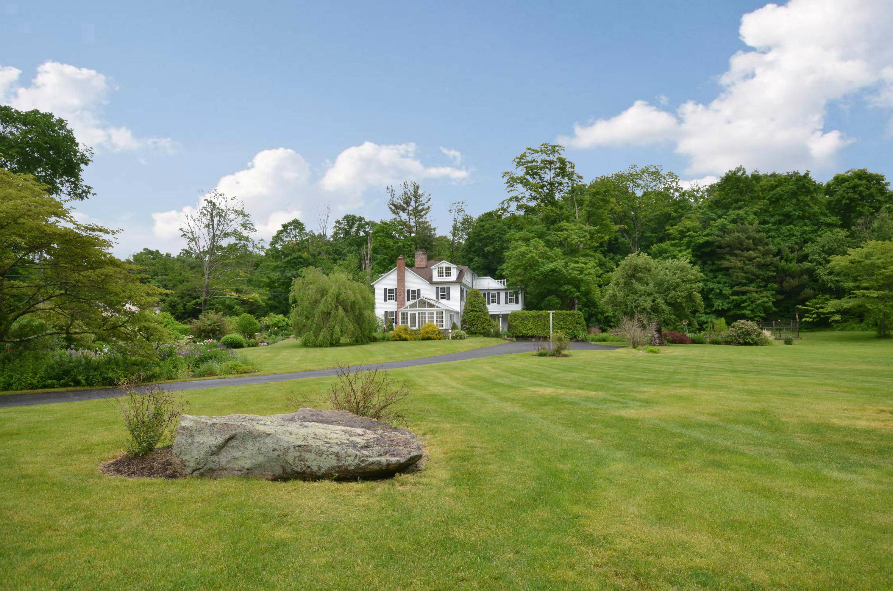 1462 Oenoke Ridge New Canaan, CT 06840 - Photo 25 of 25 a front view of a house with a yard and trees