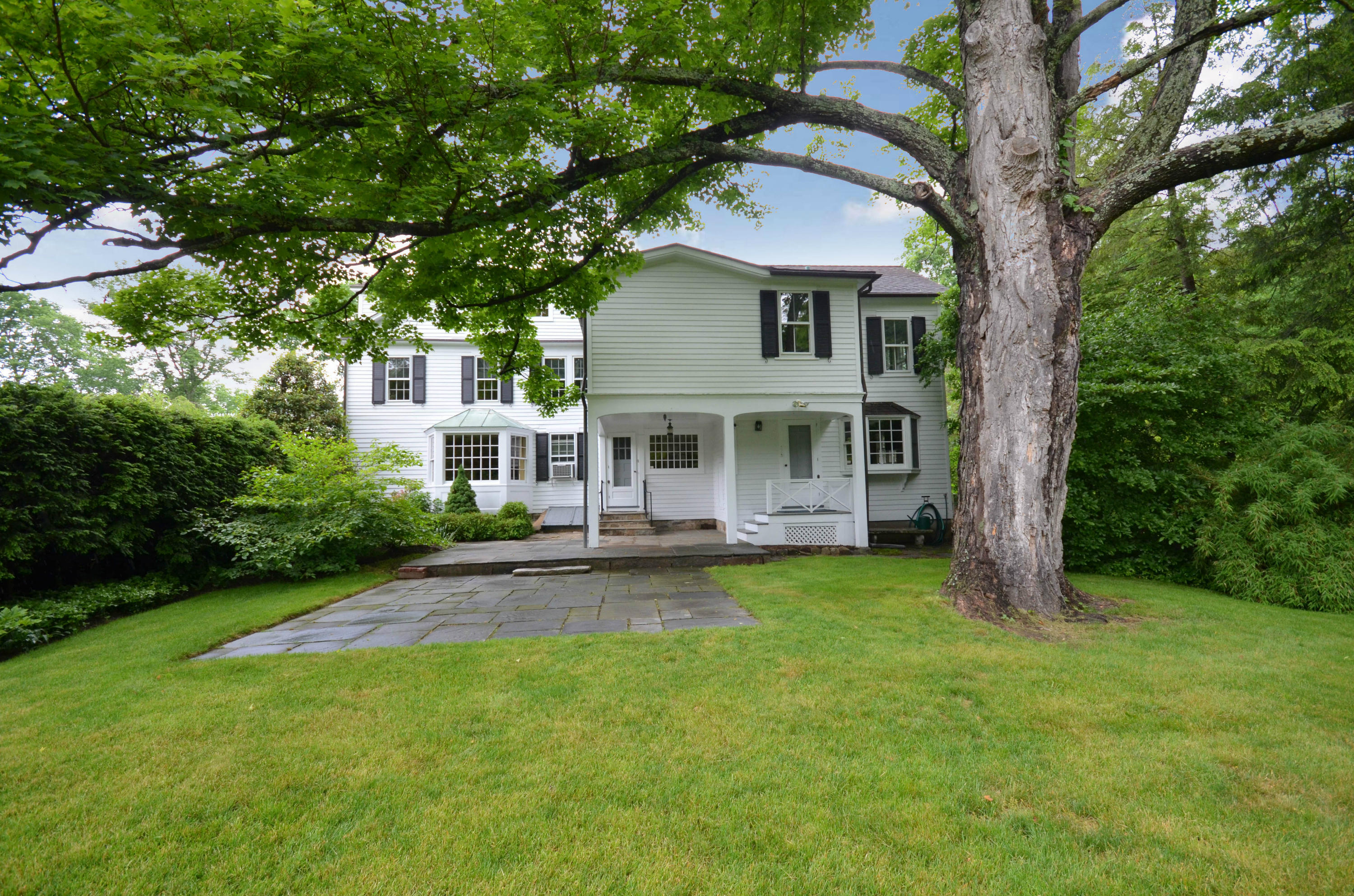1462 Oenoke Ridge New Canaan, CT 06840 - Photo 3 of 25 front view of a house with a yard