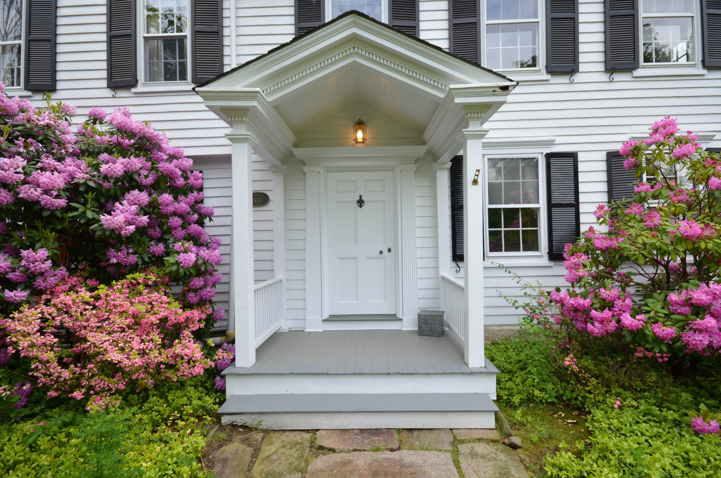 1462 Oenoke Ridge New Canaan, CT 06840 - Photo 4 of 25 a front view of a house with a lots of flowers
