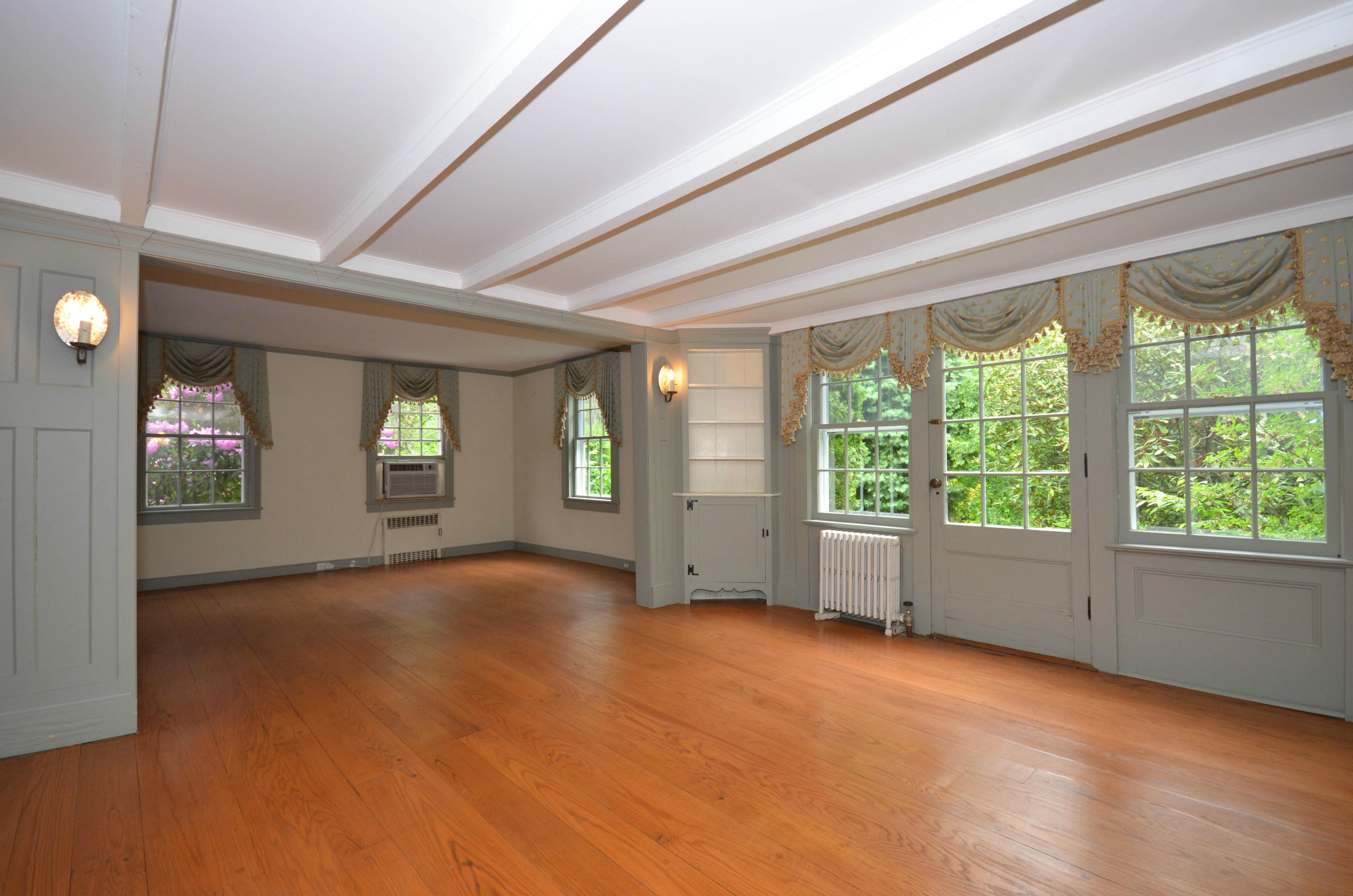 1462 Oenoke Ridge New Canaan, CT 06840 - Photo 8 of 25 a view of an empty room with window and wooden floor
