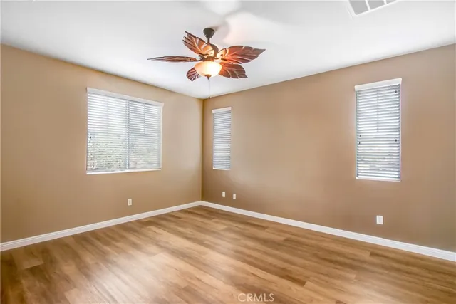 a view of a room with a window and ceiling fan